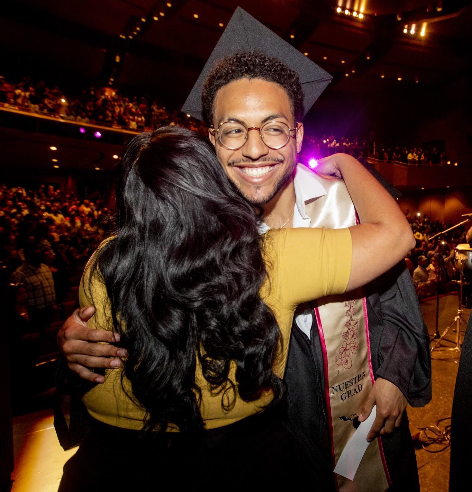 Nuestra Grad smiling while giving a hug